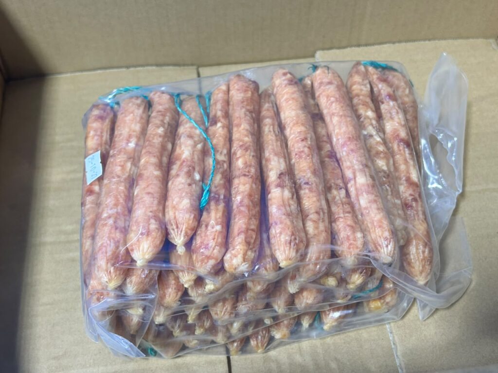 Pack of Chinese Sausage with green string ties. Each pack weighs 3kg and contains approximately 60 pieces. Wholesale delivery price is RM63 per pack. Minimum Order Quantity (MOQ) applies. Contact for further discussion, pricing details, and delivery arrangements.